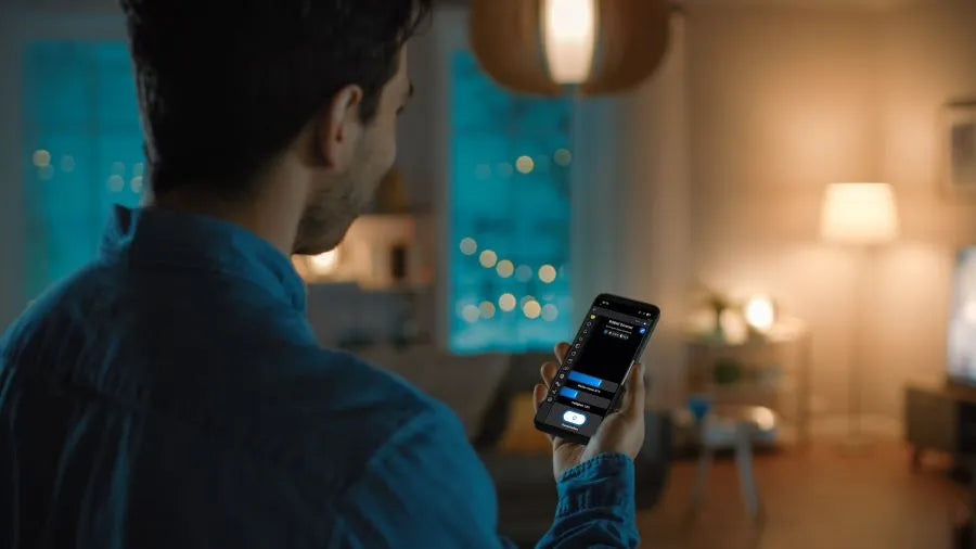 Man controls light via smartphone - dim LEDs in rental apartments with retrofit solutions, and no drilling required.