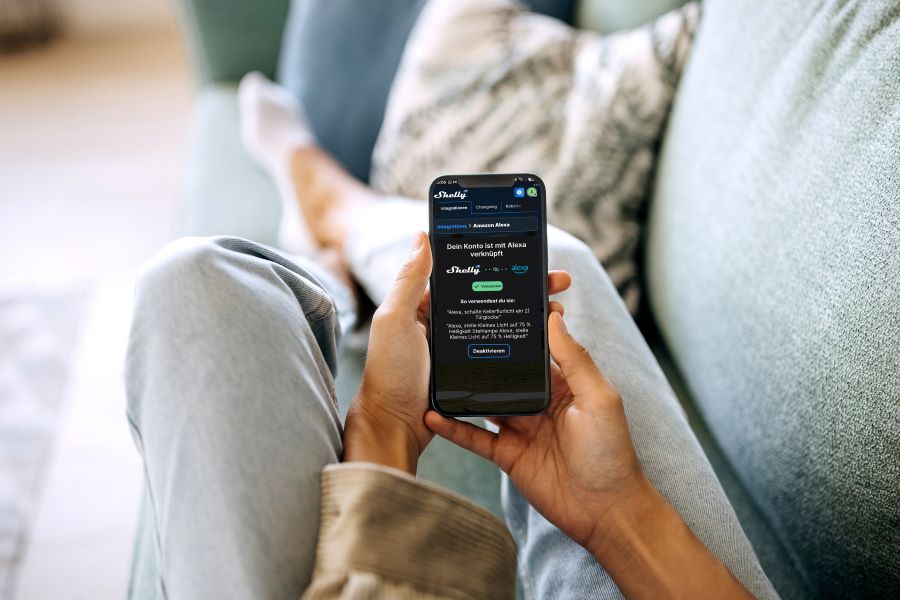 woman on sofa sets scenes in the Shelly app; Alexa voice control triggers Shelly routines