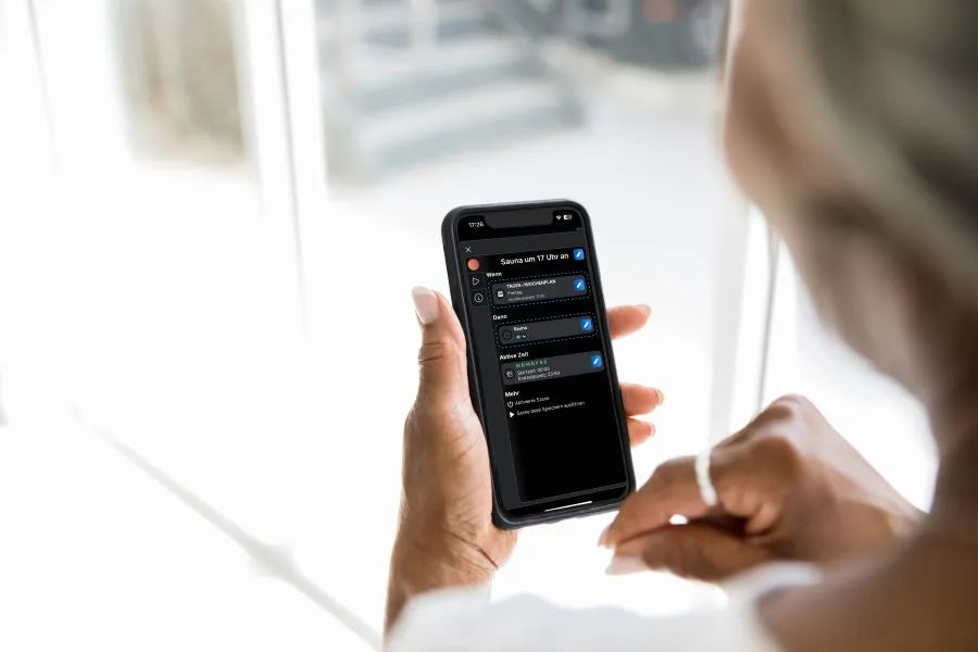 woman sets time control and scenes for the sauna heater in the Shelly app